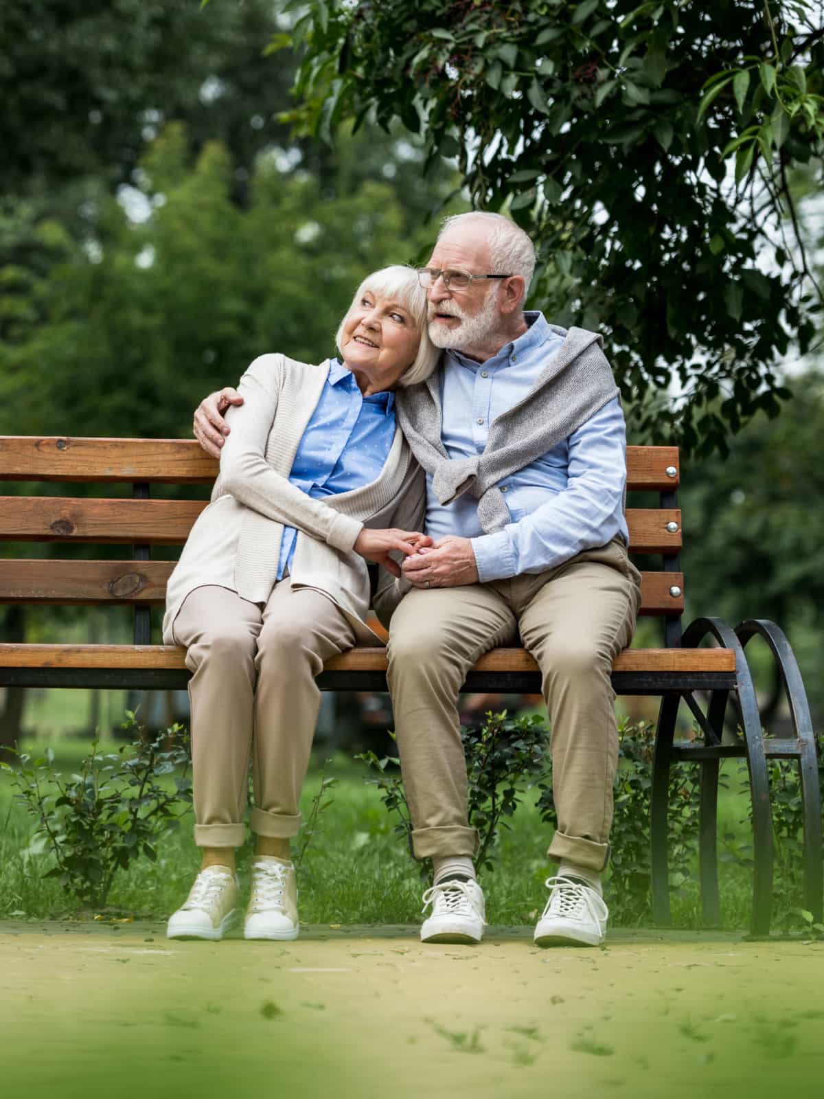 Couple sitting on a bench together.