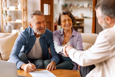Senior couple talks with retirement living consultant.