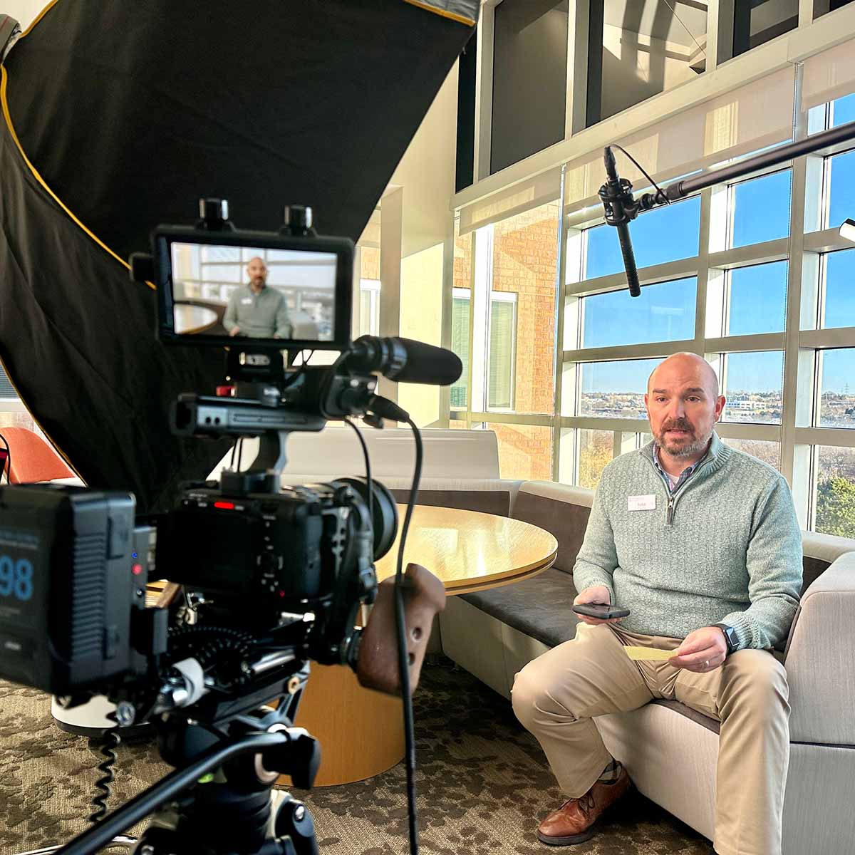Employee is presenting to a video camera.