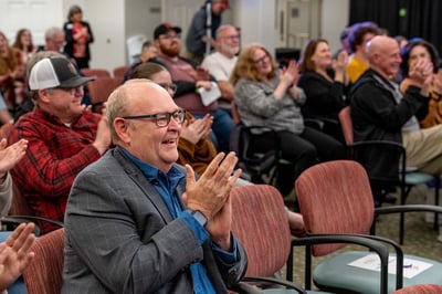 Immanuel President and CEO Eric Gurley applauds during a resident melodrama performance at The Landing retirement living community.