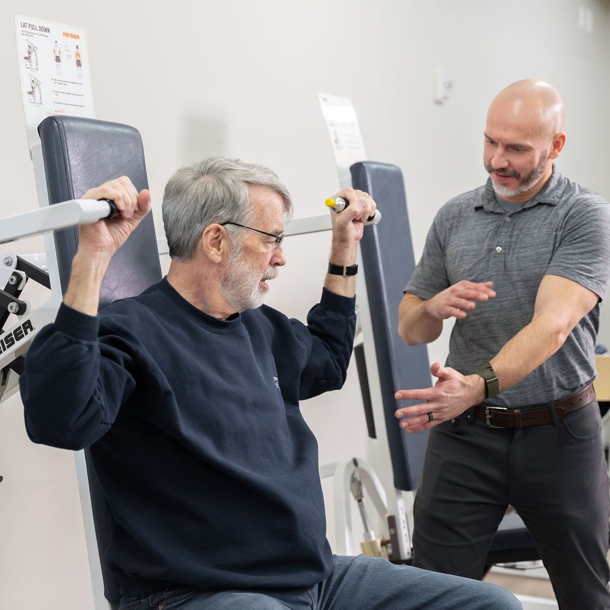 A Thrive team member provides direction to a resident during their exercise session.