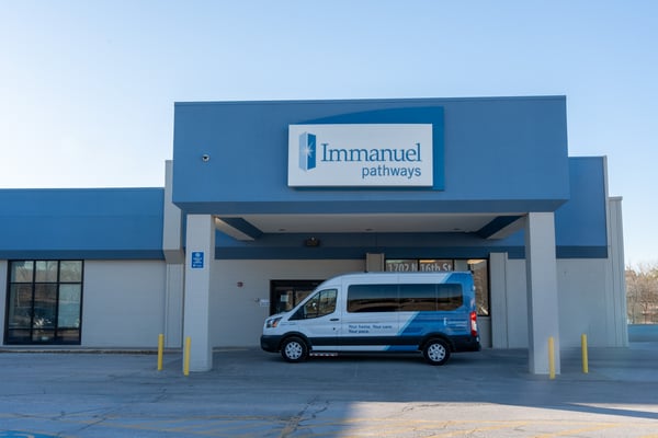 An Immanuel Pathways employee greets a PACE® participant. 